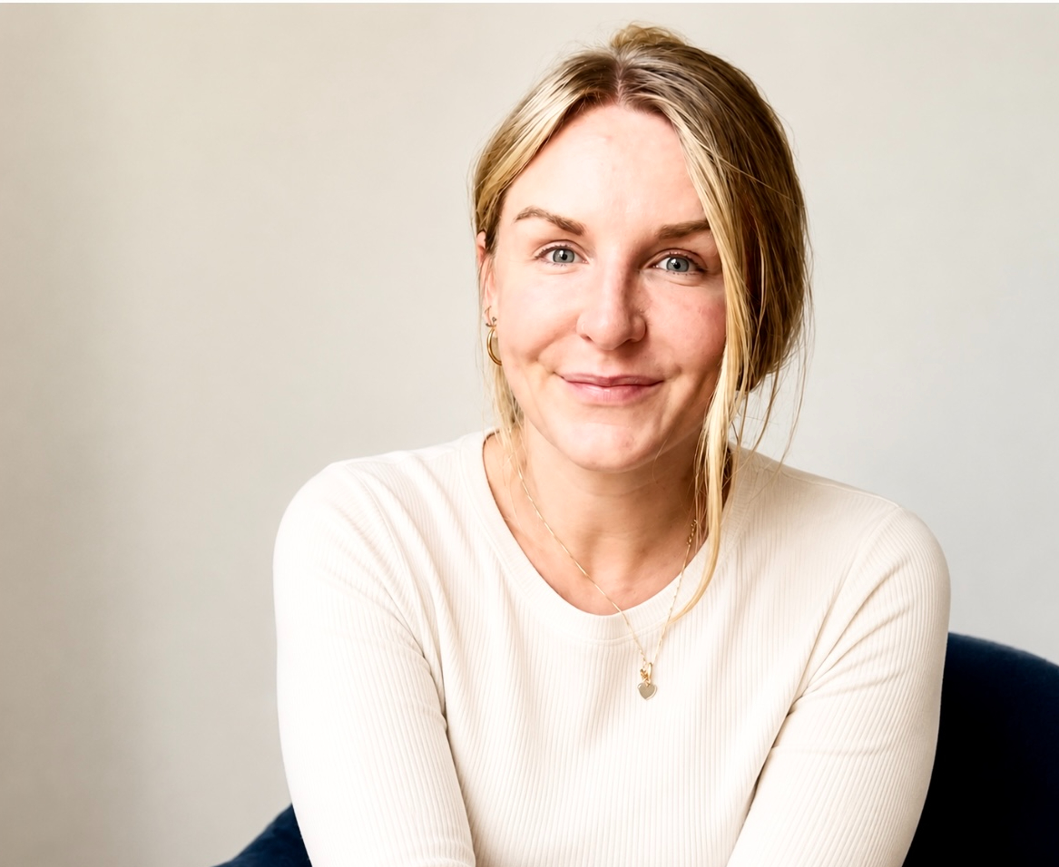 Kayla, professional nanny and home organiser, smiling in a cream jumper
